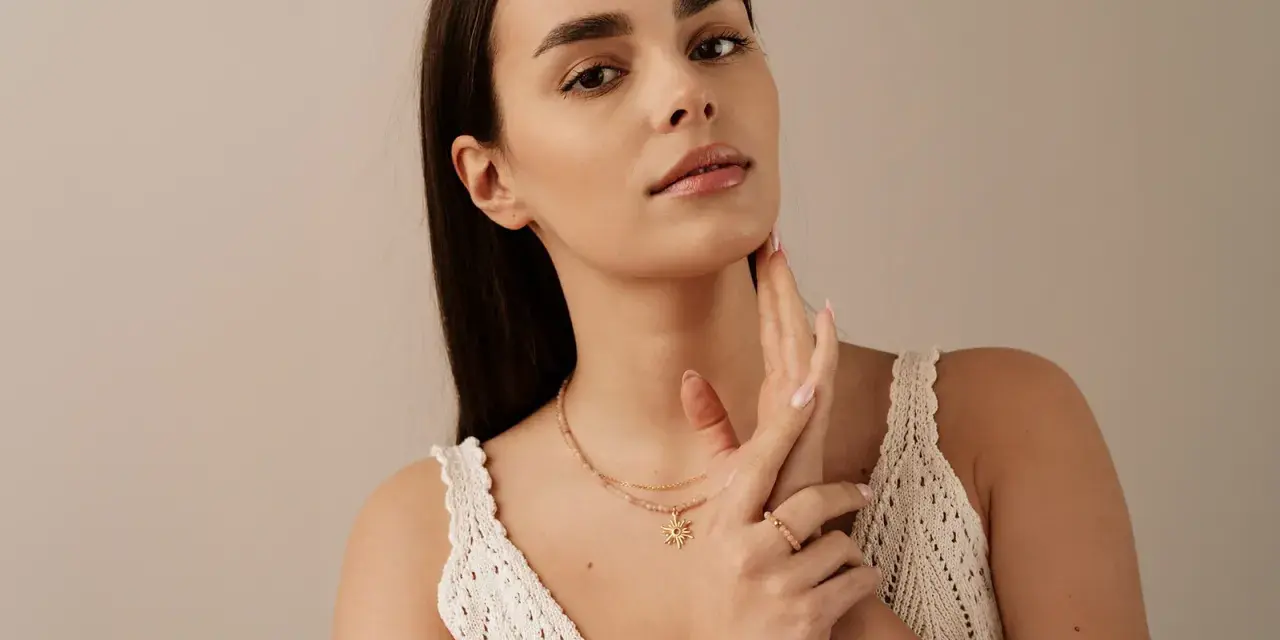 Delikatny naszyjnik z zawieszką w kształcie słońca, który pięknie podkreśla co oznacza choker na szyi.